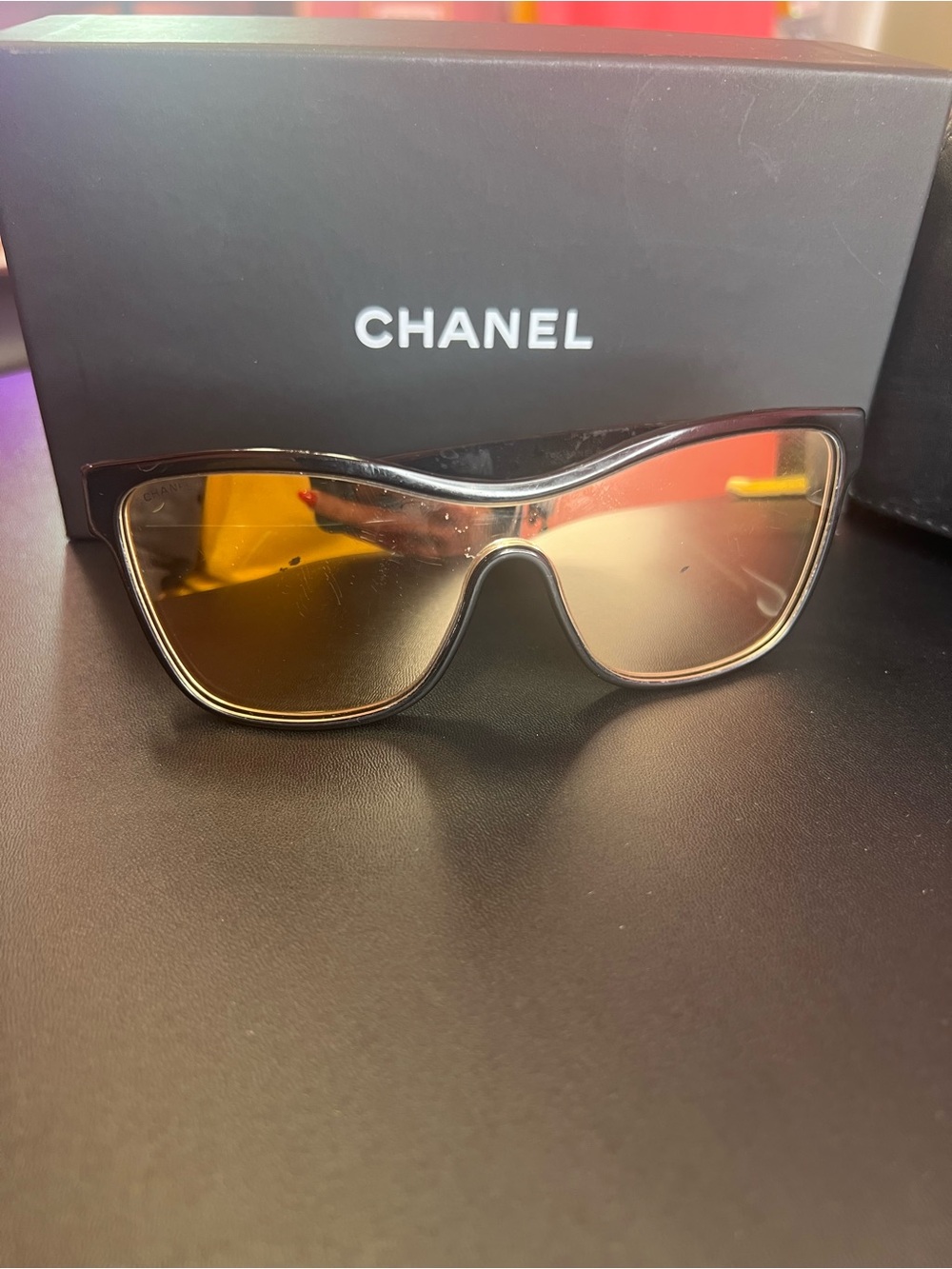 CHANEL Black Frame Sunglasses with gold mirror lenses & gold hardware.